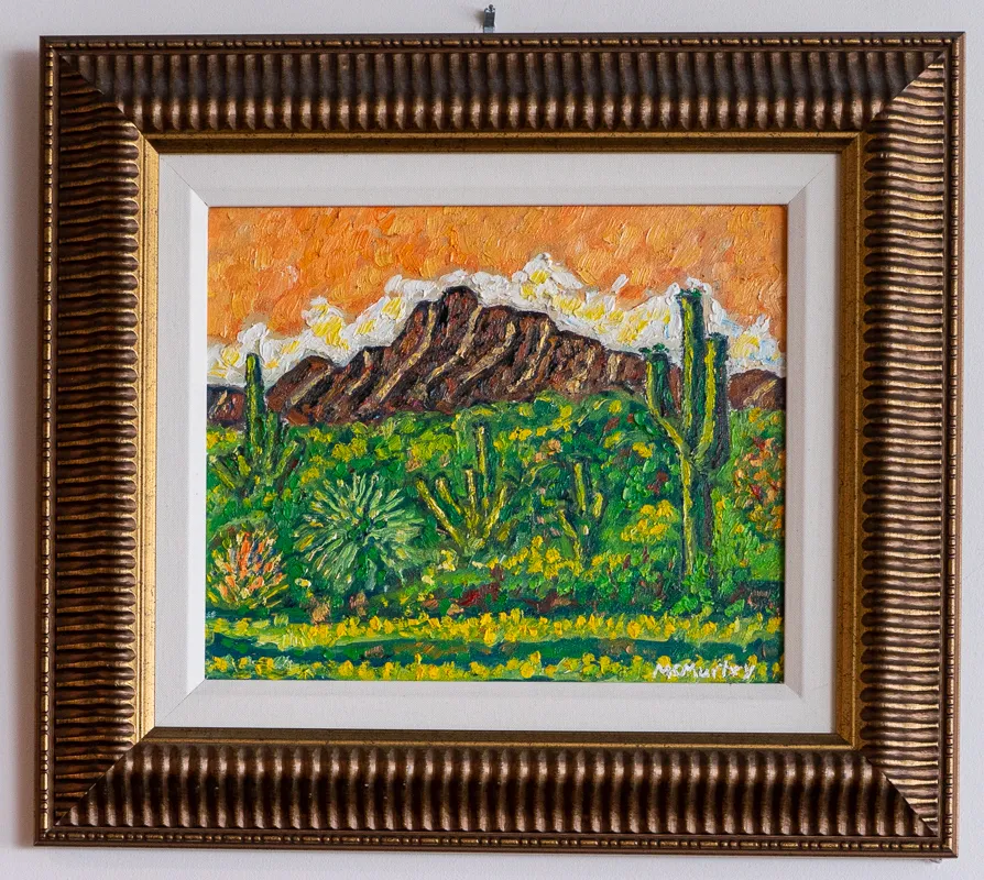 Green cacti in front of a brown bute.