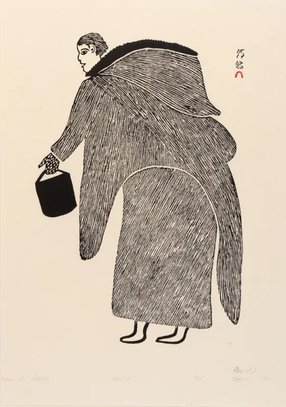 Woman in an amauti carrying a water pail.