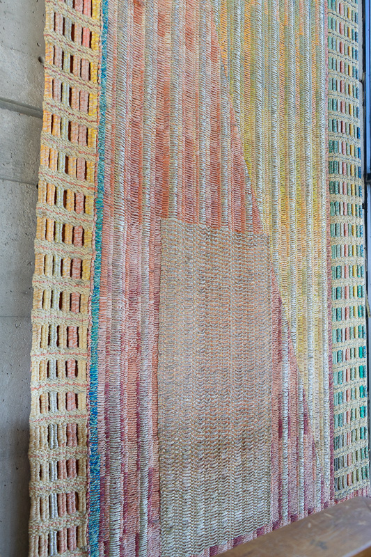 Large abstract tapestry hanging in situ.