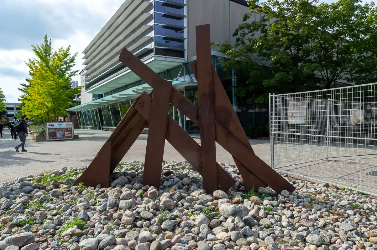 Sculpture of large welded sheets of raw steel with prefabricated fragments.