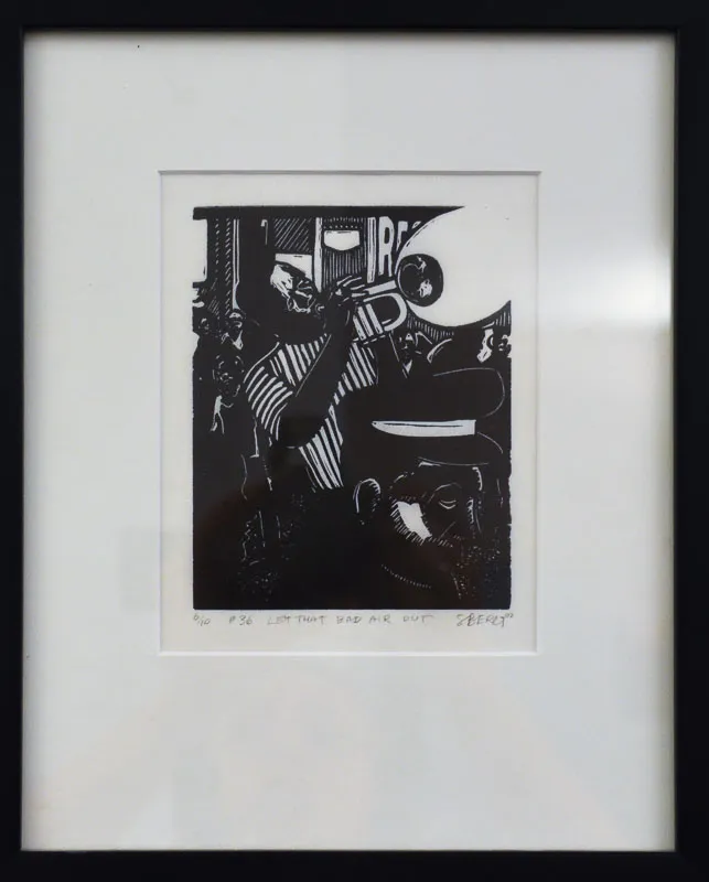 Man playing a trumpet in a black and white print.