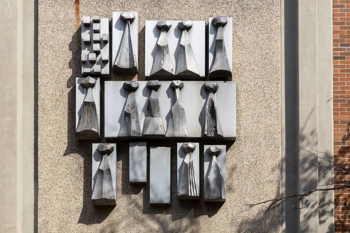 Walter Yarwood’s cast aluminum Crest, hung above the entrance to Founders College.