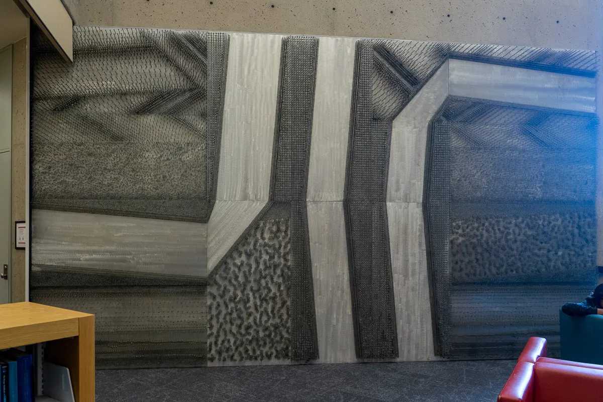 Abstract geometric wall mural made with large nails.