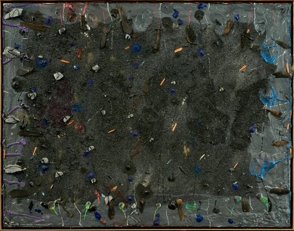 Dark painting with stones embedded on the surface.