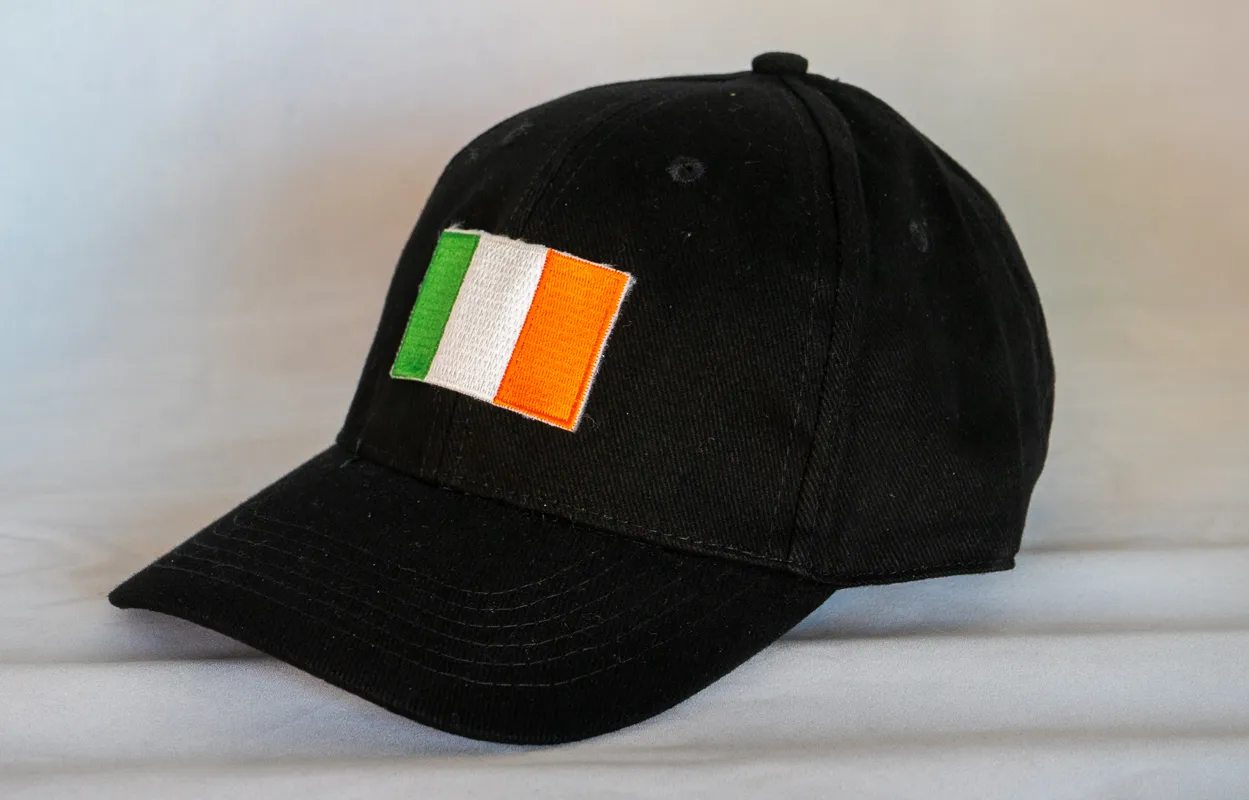 A black baseball hat with an Irish flag on it.