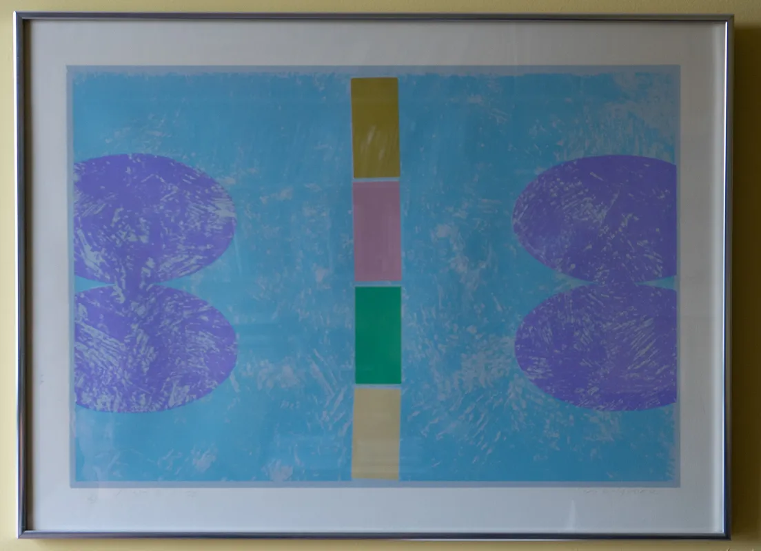 Geometric print, primarily blue, with a vertical line of varying colours down the middle and two oblongs on each horizontal side.