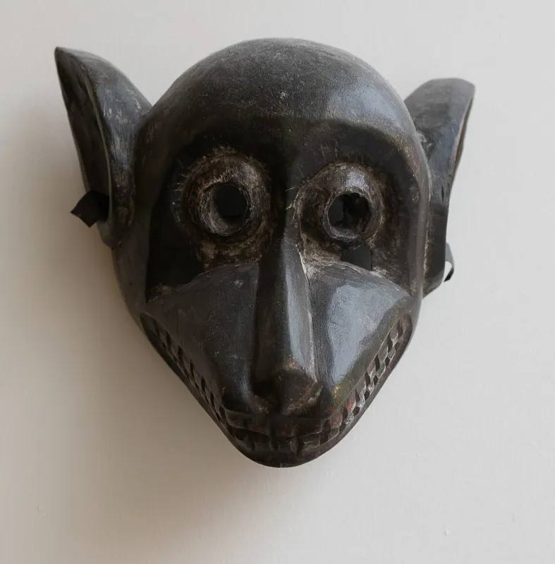 Grimacing bear-like animal mask with teeth bared