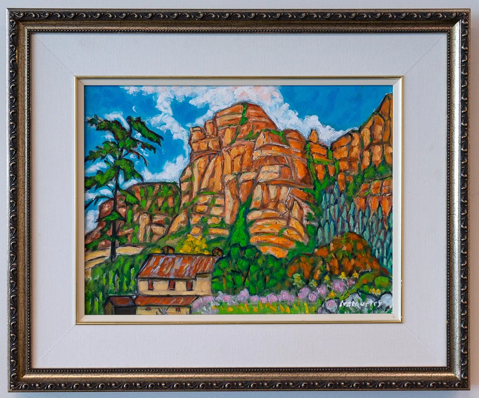 A house below some cliffs.