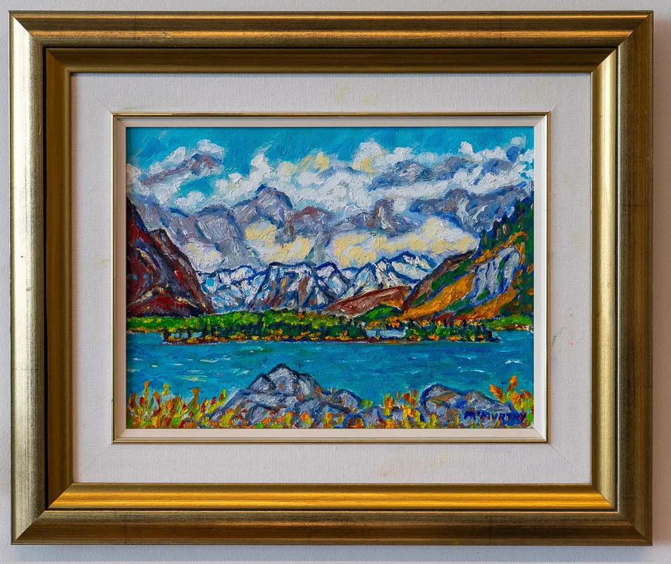 Mountains and trees across a body of water.