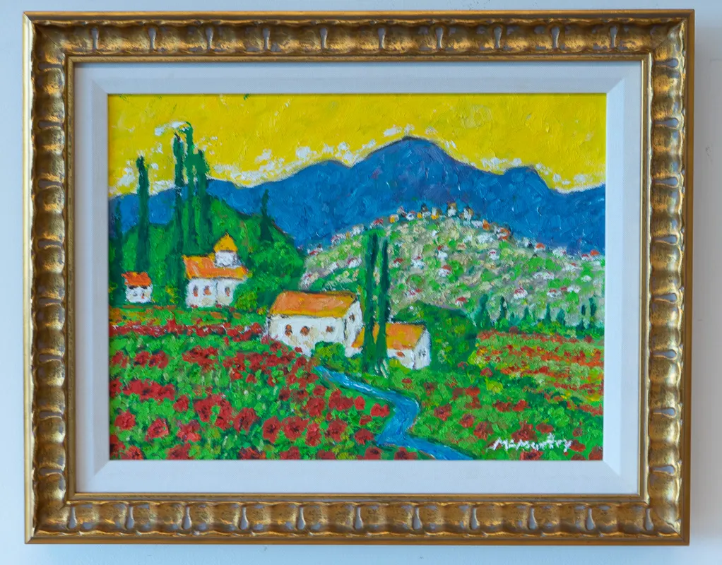 White farmhouses with orange roofs in the midst of a field of flowers. Blue mountains in the distance are topped by a yellow sky.