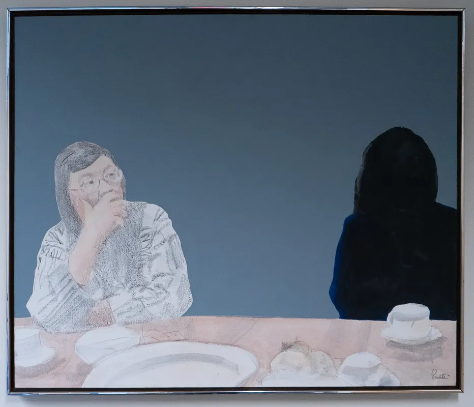 Margaret laurence at a dinner table. Her companion is merely a silhouette.