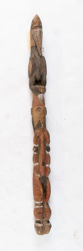 Short staff shaped like human with bird perched on head.