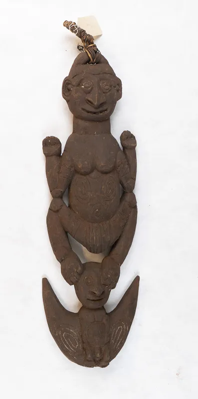 Carved wooden pendant with single human figure.