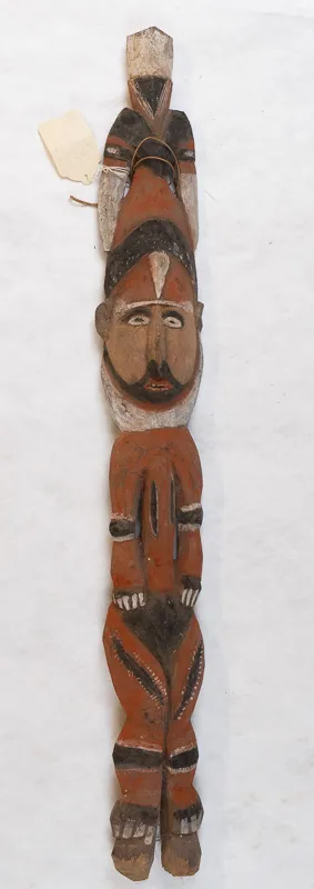 Carved wooden person with mustache and beard.