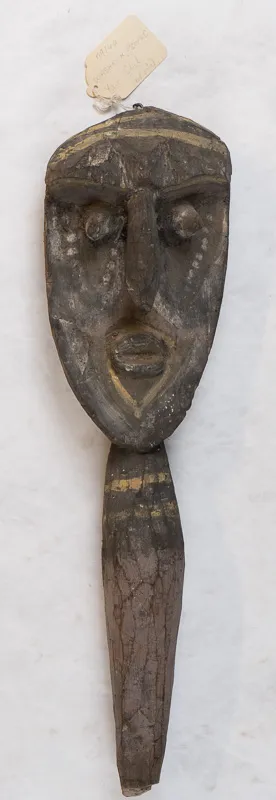 Digging stick (handle) as carved face.