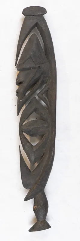 Stylized figure in dark wood.