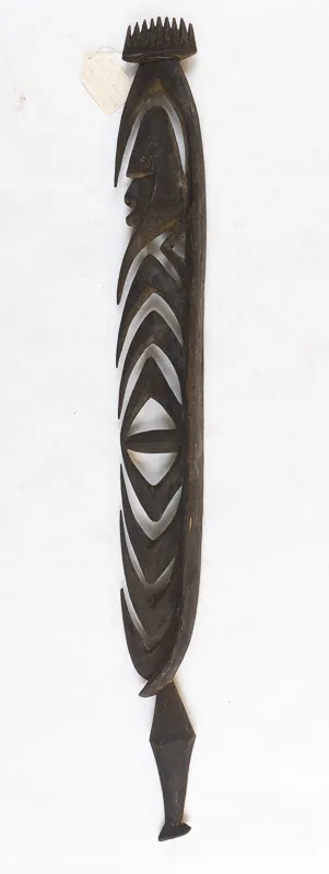 Stylized figure in dark wood.