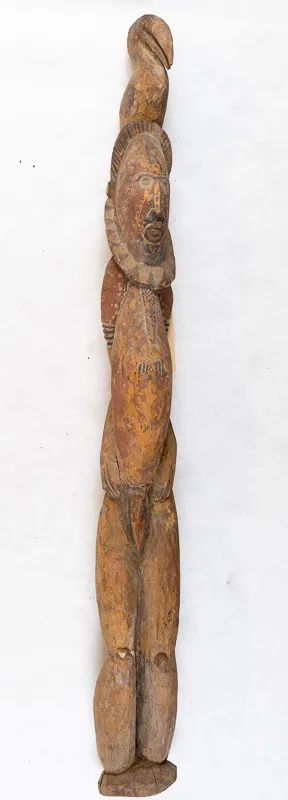 Skinny anthropogenic figure with bird on head, carved in yellow wood.