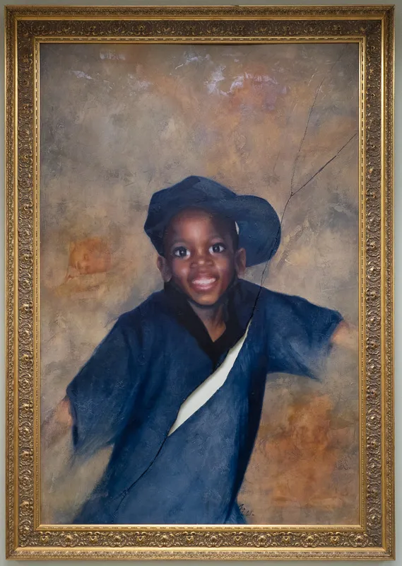 Portrait of a young boy of African descen. there is a painted crack running diagonally across the image, appearing to be a reproduction of a folded photograph.