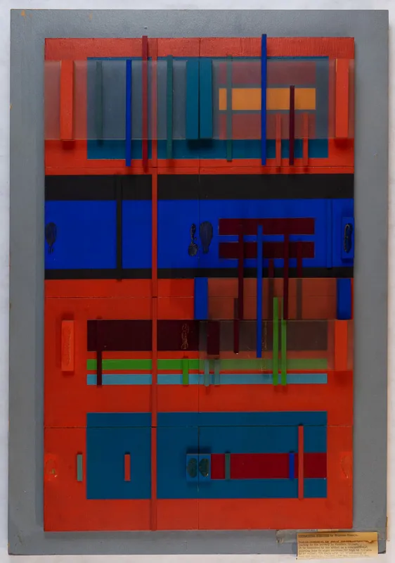 Wood and plastic geometric bas relief in primarily blues and reds.