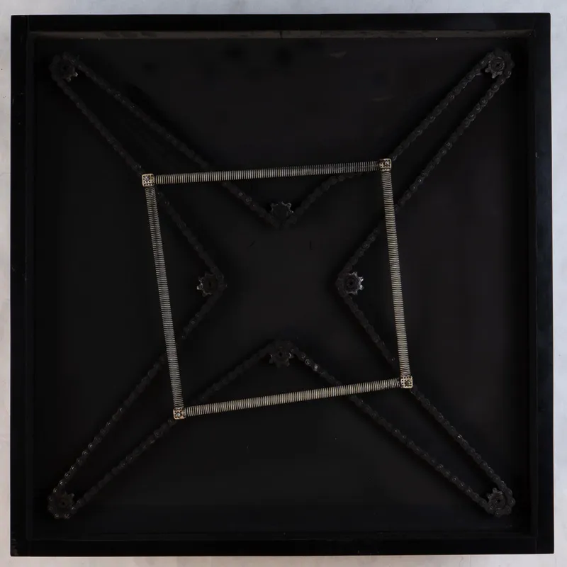 Square black object with springs.