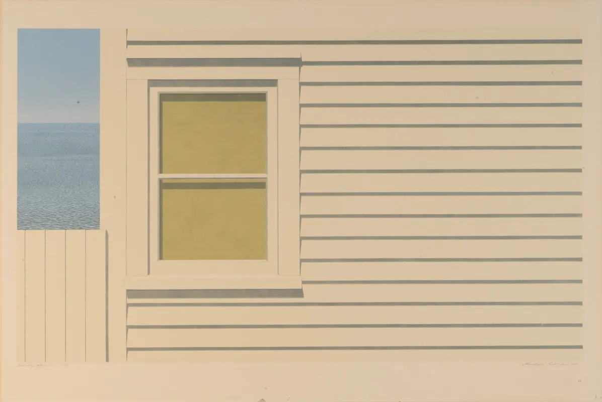 Side of a building with a glimpse of a body of water in the upper left. Very geometrical.