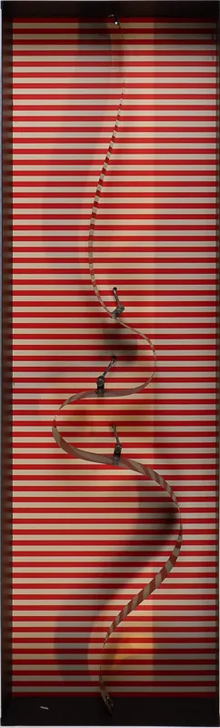 Box with a curvy metal ribbon running from top to bottom. When activated, the ribbon undulates.