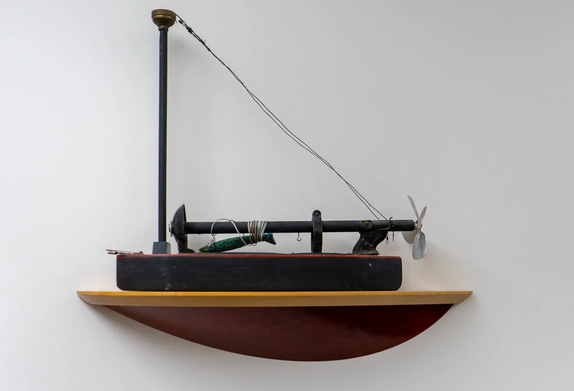 A small boat made out of wood scraps.