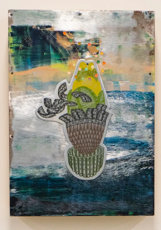 A metal vase with tropical fruit against an abstract background.