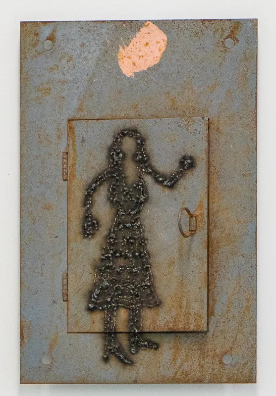 Outline of a woman welded onto an electrical box.