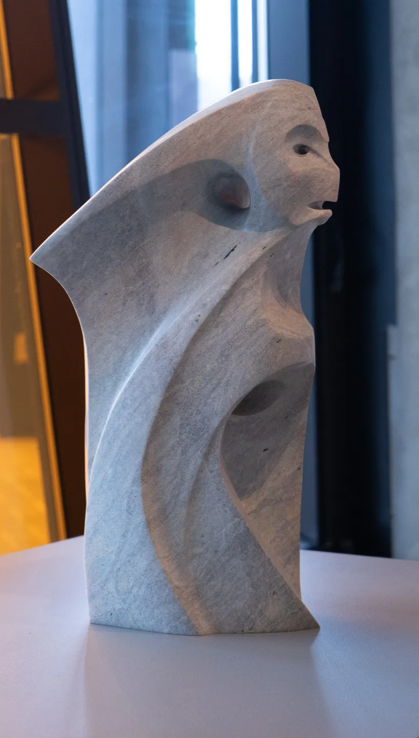 Stylized female figure, reminiscent of a hawk.