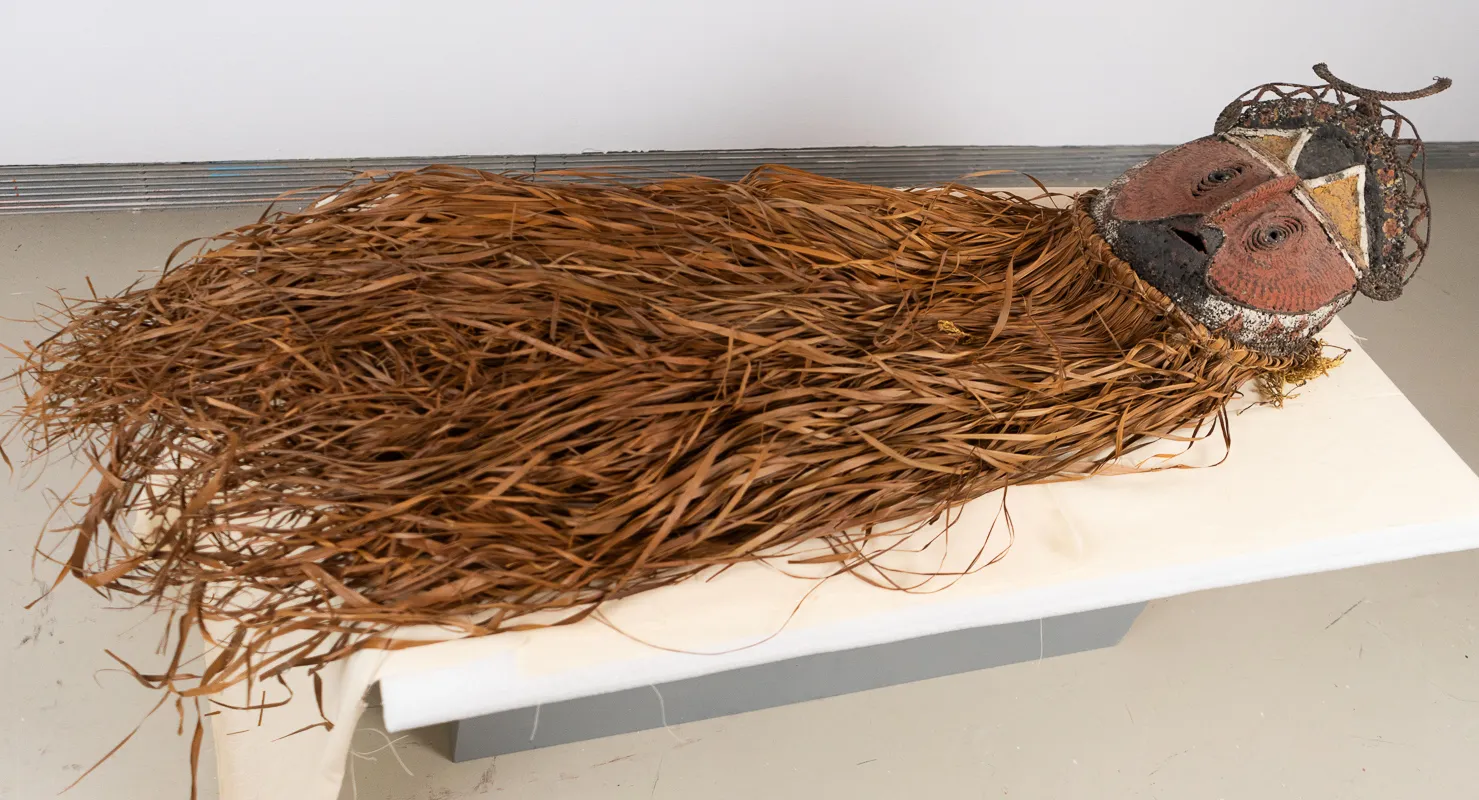 Mask with long 'beard' in leaves or reeds.