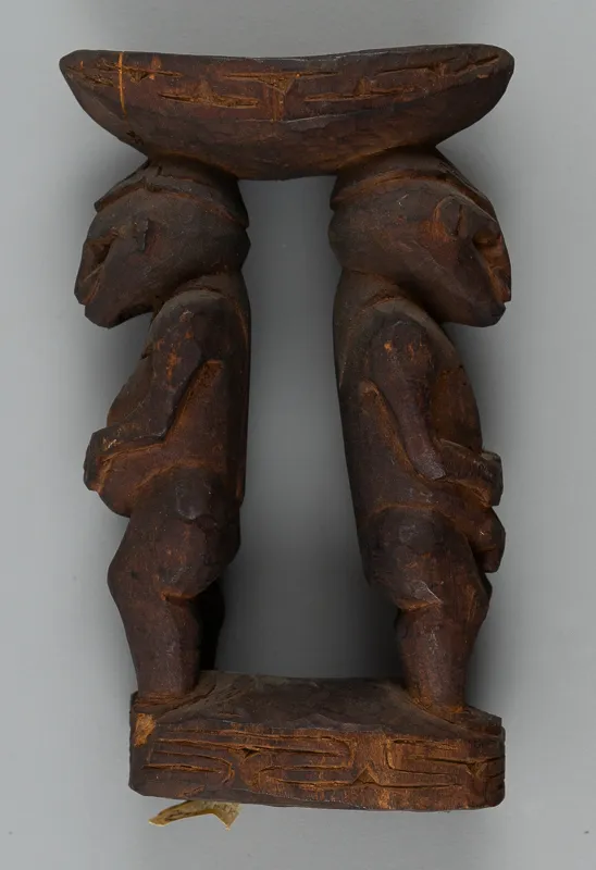 Small wooden carving in dark wood.