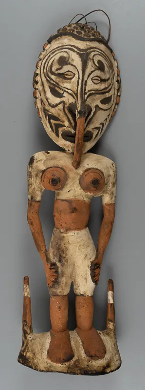 Carved human figure with pegs in the base for hooking onto.