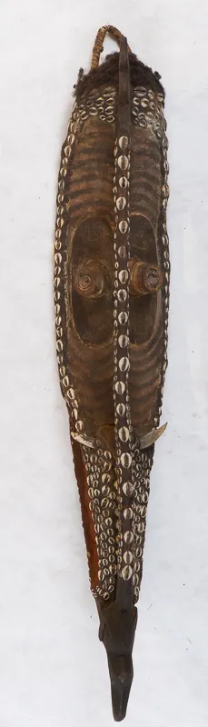Mask in wood with shell decorations.