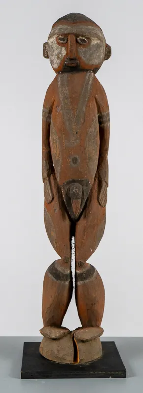 Carved wood figure in red, black, and white.