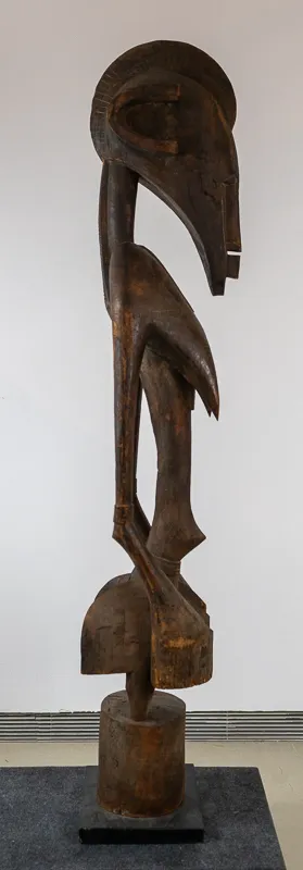Larger carving depicting a stylized woman in dark wood.