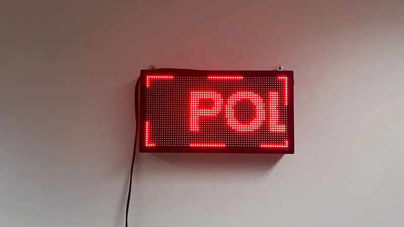 A red LED sign that reads 'Politics' in a continuous loop.