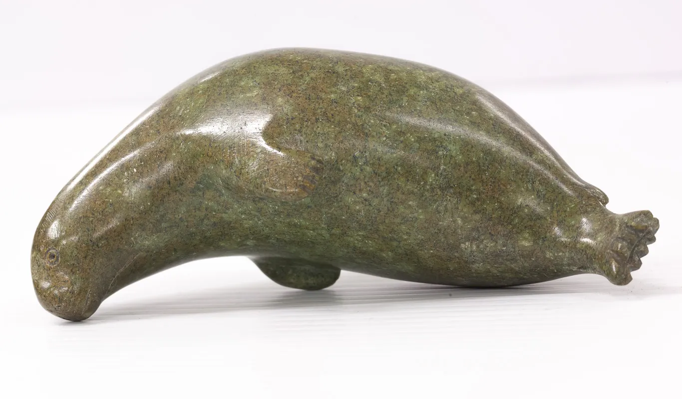 Seal in green stone precariously balanced.