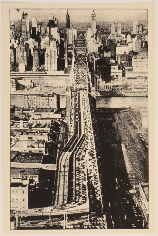 Bird's eye view of a cityscape and highway.